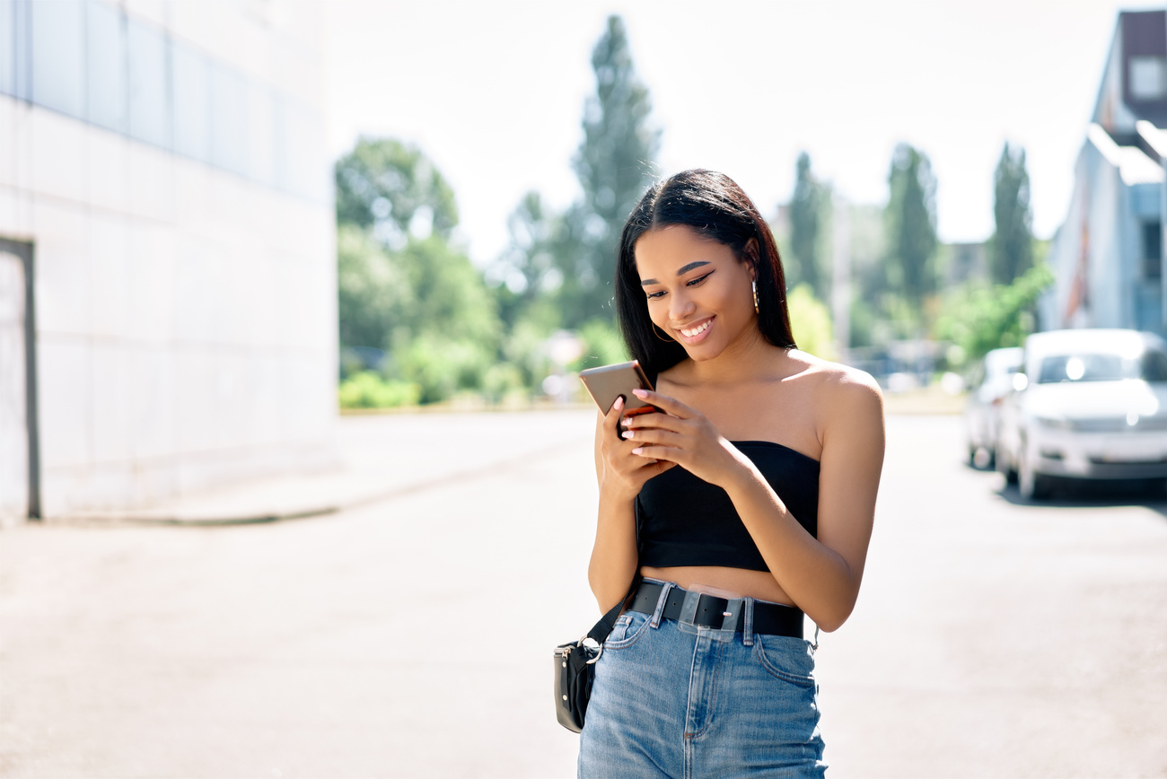 Young Woman Texting Outdoors 